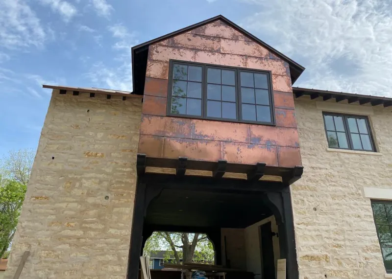 Copper metal panel facade on a stone building for Skylight Installation in Fairbanks