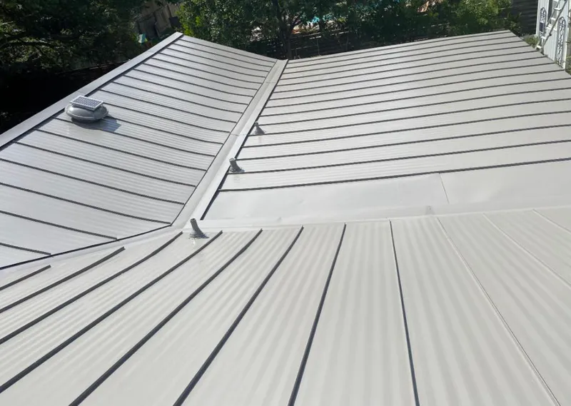Solar attic fan installed on a metal roof for Roof Ventilation in Fairbanks